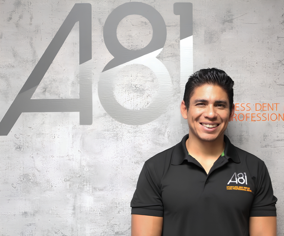 Adan Solis — A81 Dent Repair founder performing paintless dent repair